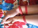 in bed with red wristband
